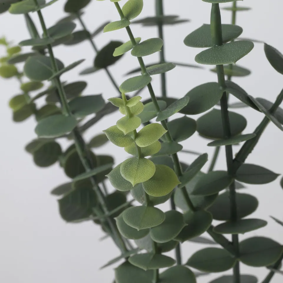 Artificial eucalyptus plant with vibrant, green leaves made from recycled plastic, showcasing lifelike detail and adjustable steel-reinforced stems.