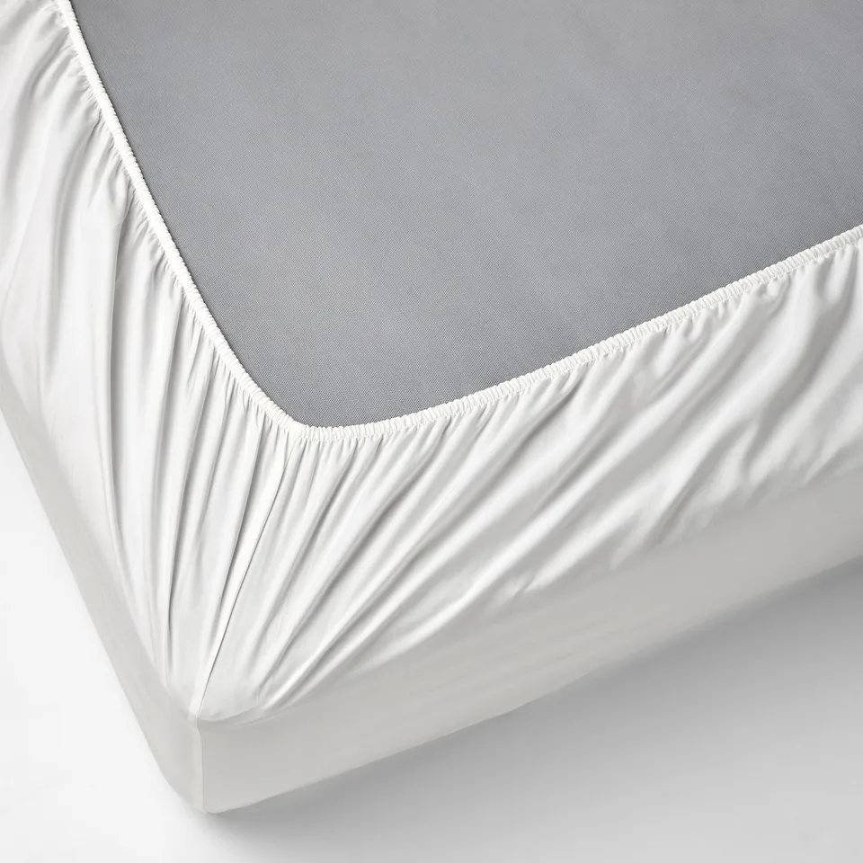 White bed sheet set with fitted sheet, elastic corners, crisp cotton.