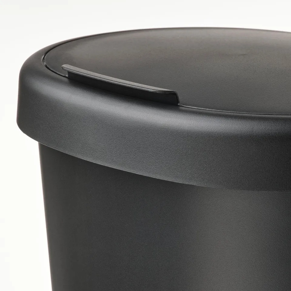 Black recycling bin with secure lid, designed for efficiency and cleanliness.