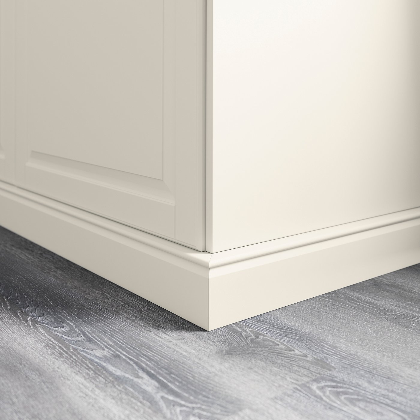 White kitchen cabinet plinth cover, neatly fitting between cabinet base and grey wooden floor.