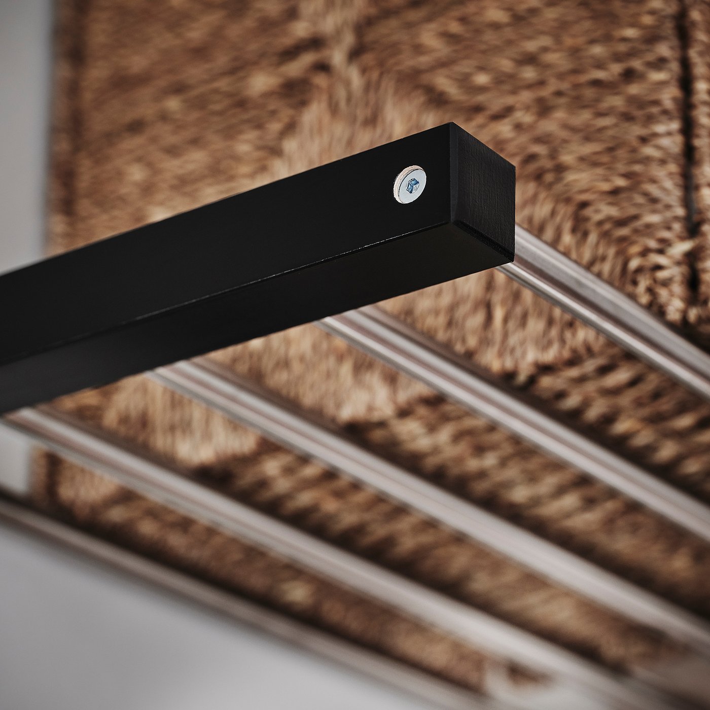 Black wooden coat rack with metallic hooks, showing quality craftsmanship and sturdy design.