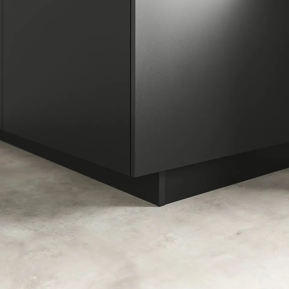 Black kitchen plinth, blending cabinets with floor, sleek & modern.