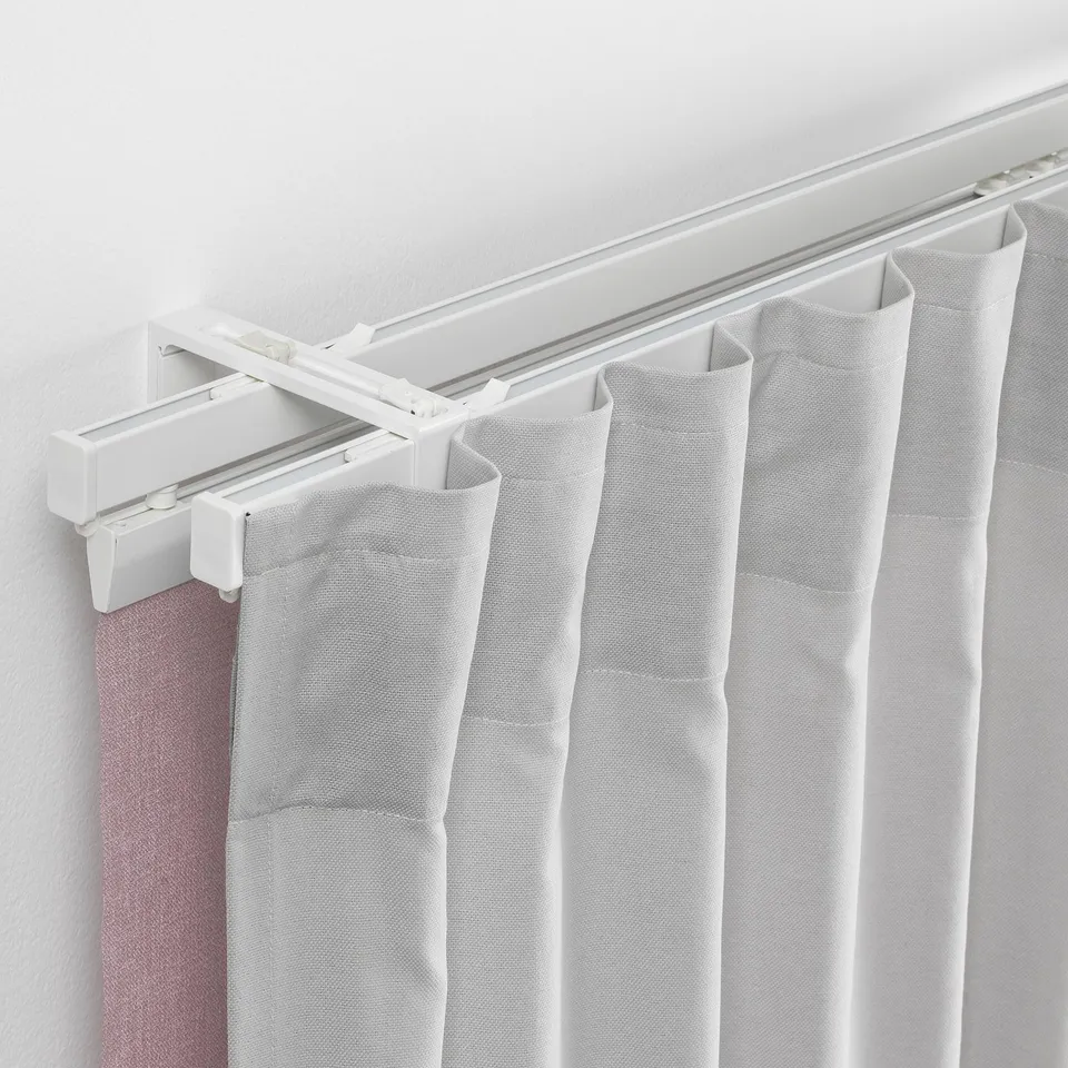 Double rod system with white curtains for privacy and light control.