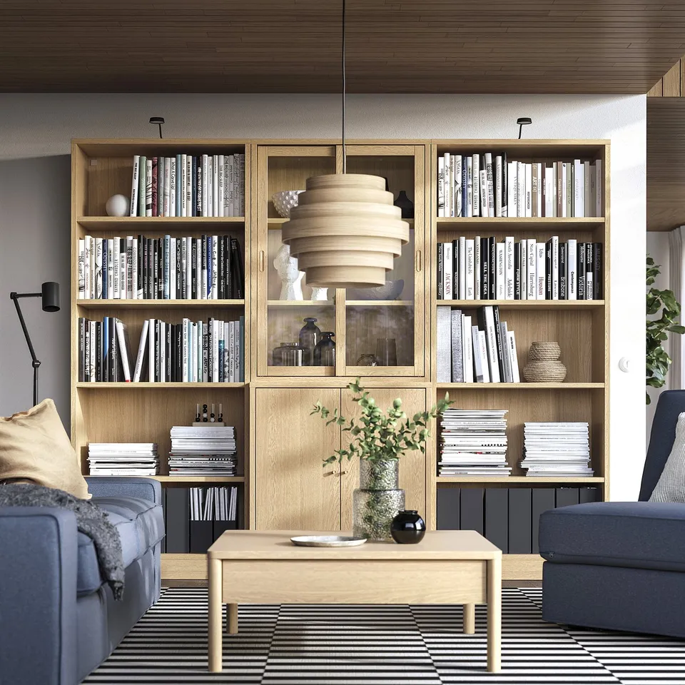 TONSTAD bookcase in living room with books, decor, and grey sofa.