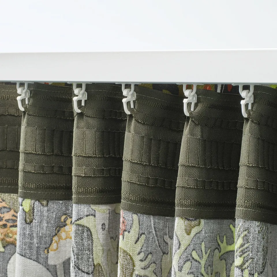 Curtains with pleated heading tape and hooks for easy hanging. The fabric philtres light and provides privacy.