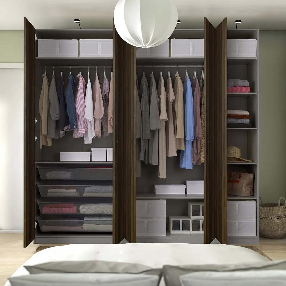 Wardrobe with clothes, folded items, and storage in plastic boxes and mesh drawers.
