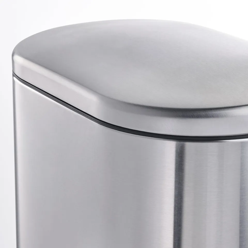 Close-up of a sleek, stainless steel rubbish cans curved, smooth lid edge, showcasing its modern, sturdy design.