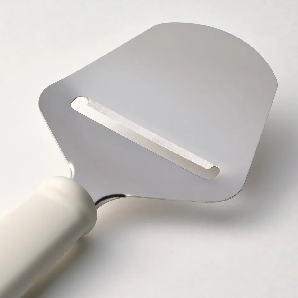 Silver cheese knife with a smooth plastic handle and a stainless steel blade, laid on a white surface.