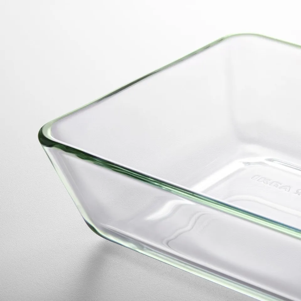 Clear glass baking dish sits alone, showcasing its smooth, transparent surface and sturdy edges.