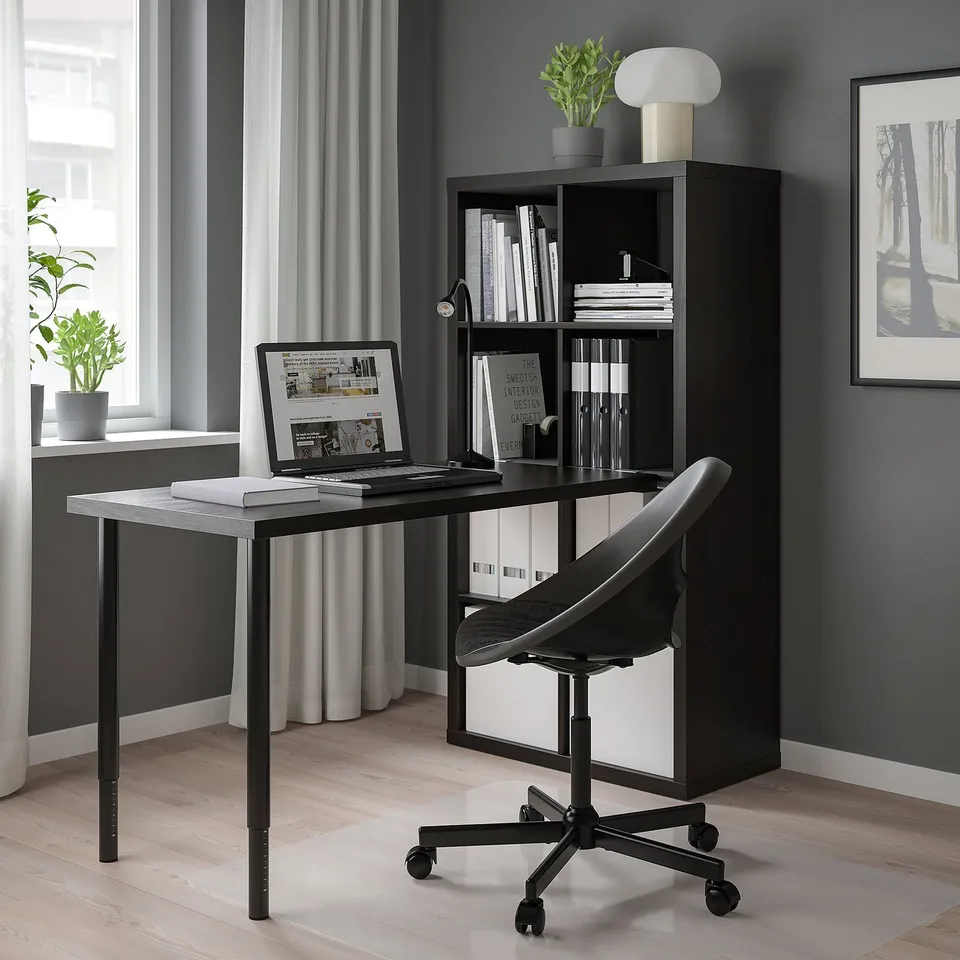 Modern home office with KALLAX shelves, desk, laptop, and decor.