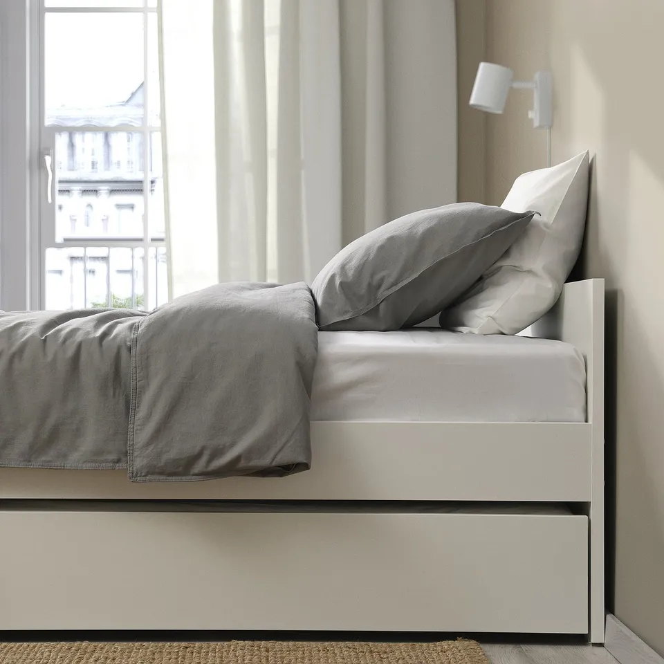 A minimalist bed frame with a hidden trundle, ideal for extra guests. It a clean design and includes a safety lock for stability.