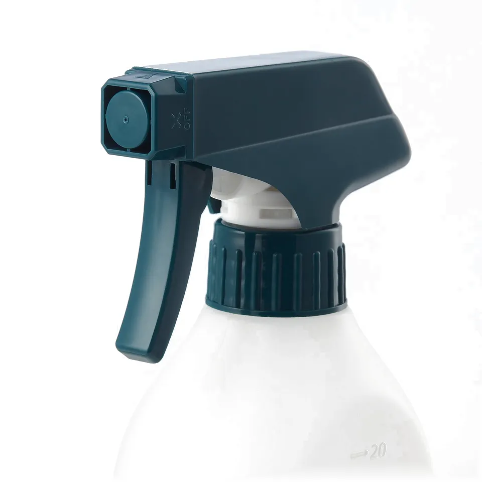 Clear spray bottle with adjustable nozzle and lock, on grey background.