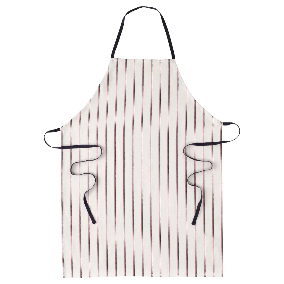 A HILDEGUN apron in white and pink stripes with black ties. Its made of 100% cotton, designed for cooking.