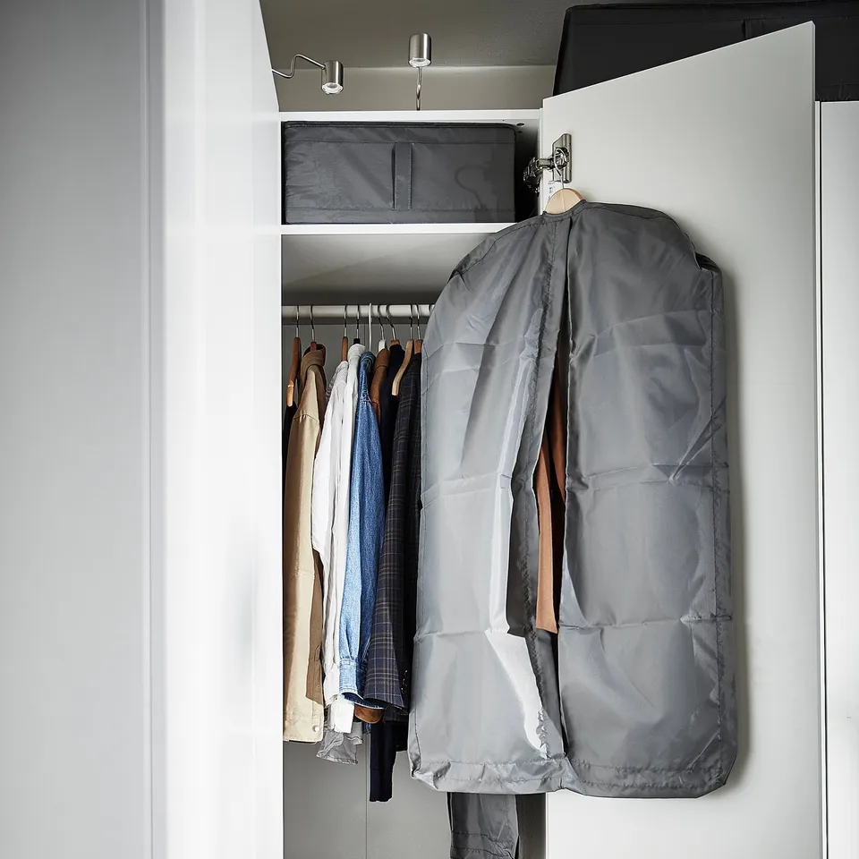 Open closet with SKUBB grey covers hanging clothes.