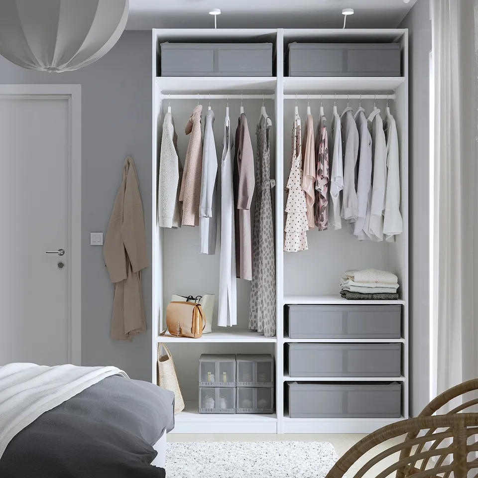 Bedroom with wardrobe featuring SKUBB storage cases, protecting clothes from dust and offering air circulation.