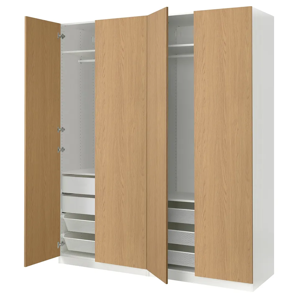 A PAX wardrobe with light wood doors, featuring drawers and shelves inside.