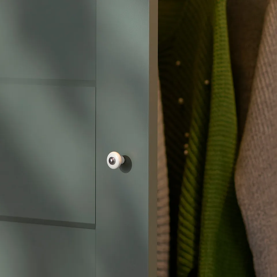 Close-up of a modern, sleek teal cabinet with soft-closing hinge.