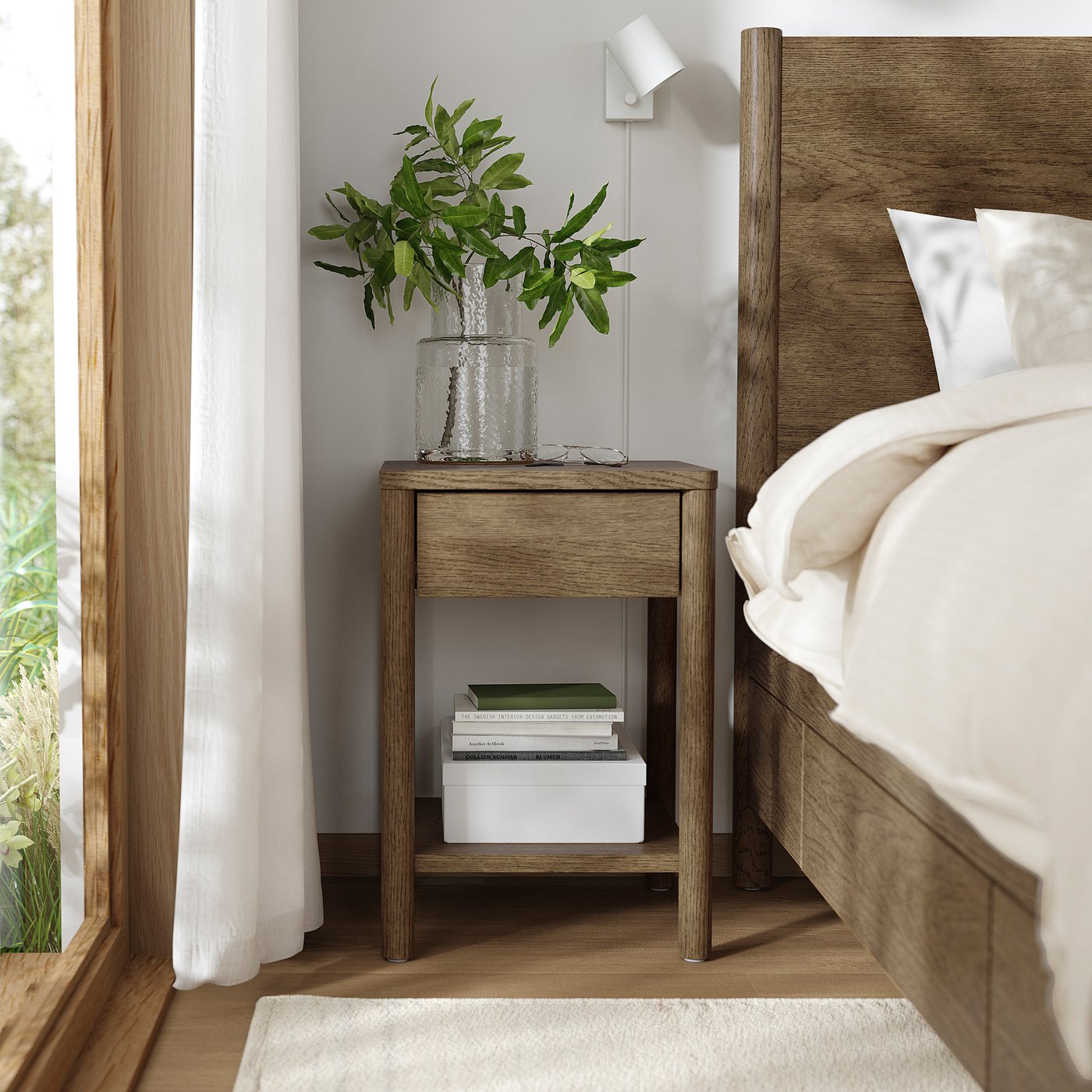 Modern bedroom with light wood bedside table, white vase, and green plant.