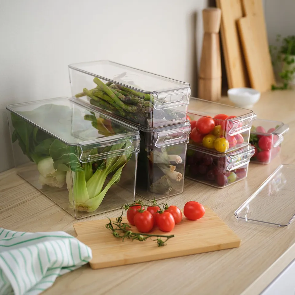 Clear fridge organisers for veggies, stackable with handles.