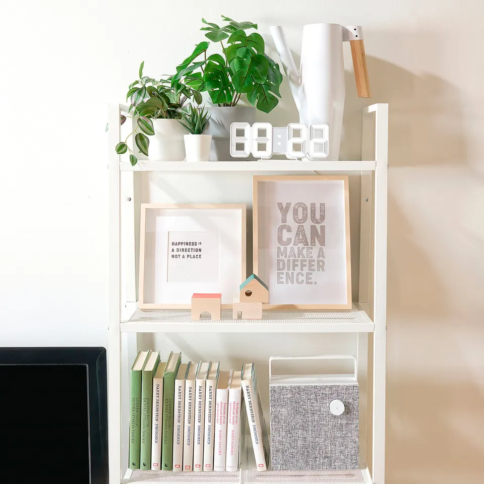A 3-shelf unit displaying books, decor, and plants. Its a versatile storage solution with open shelves.