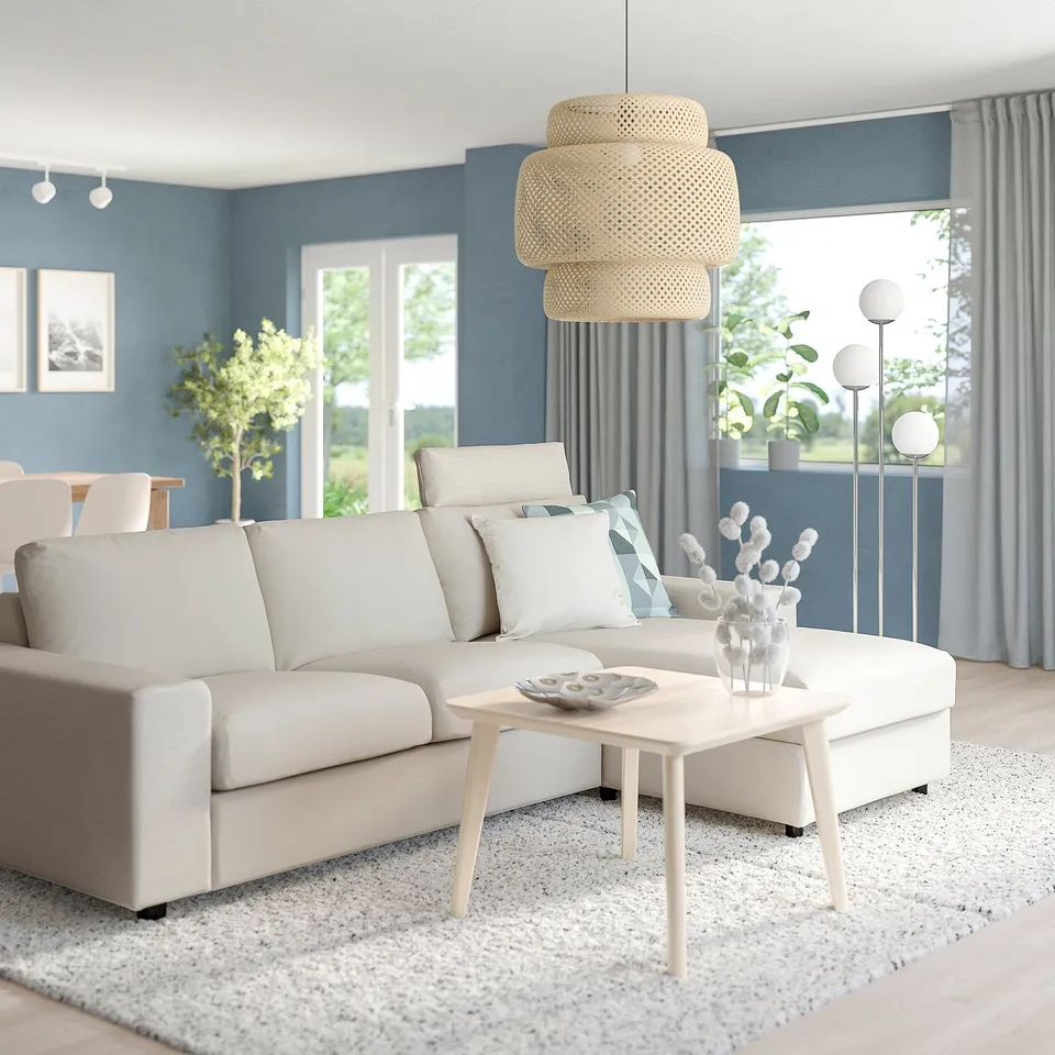 Modern living room VIMLE sofa in beige, with a white coffee table and large windows. The sofa is spacious with a chaise attachment.