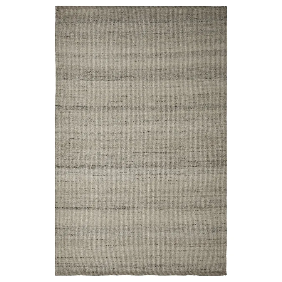 The TIDTABELL rug, a rectangular grey wool and cotton floor covering with a subtle, striped pattern.
