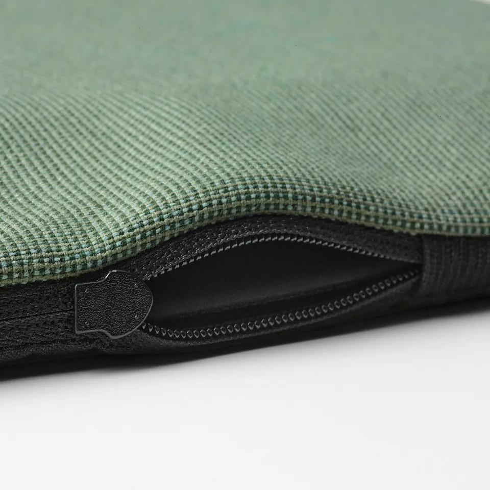 Closeup of a green anti-slip mats zip and fabric texture.