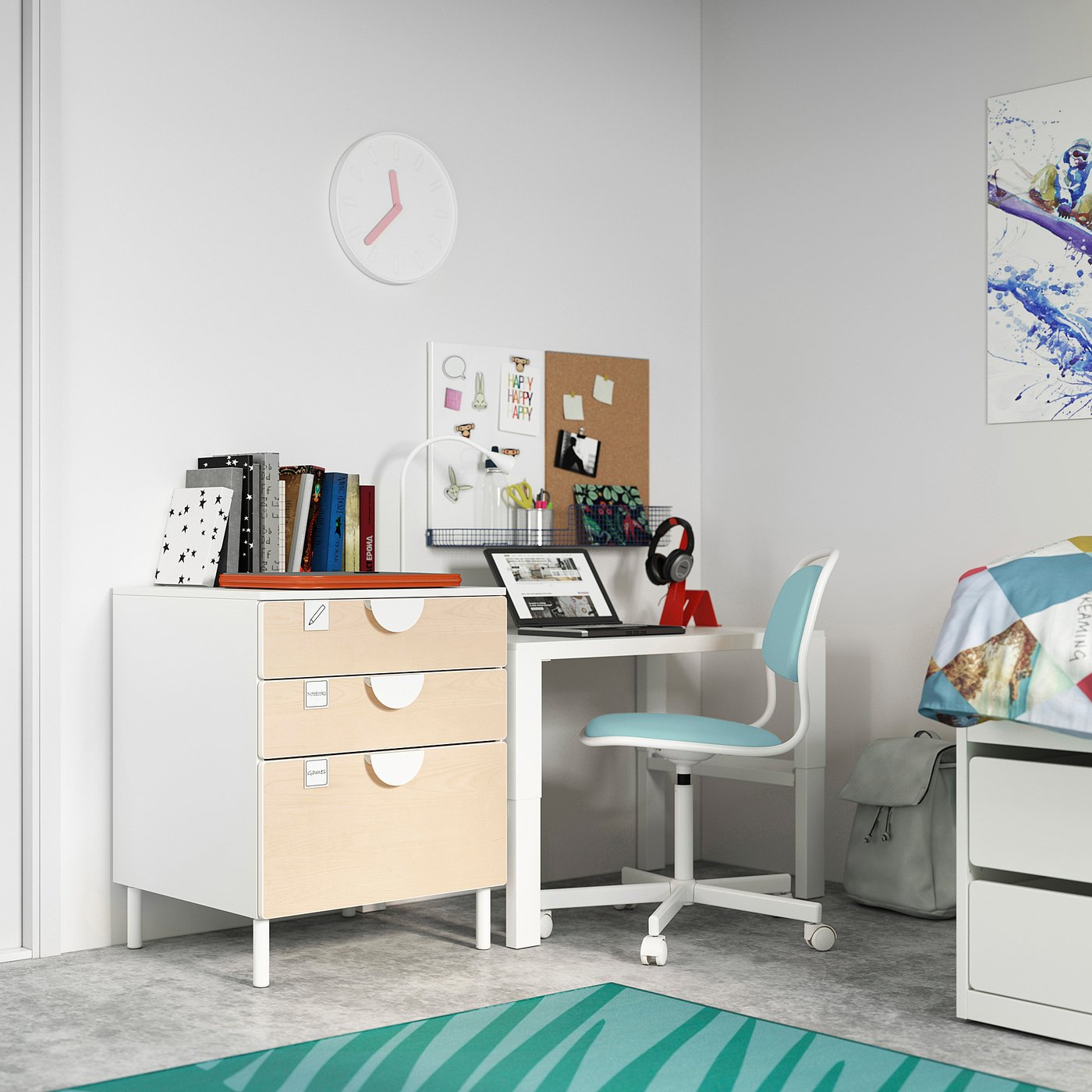Childrens room with white SMÅSTAD desk, light blue chair, wooden drawers. Laptop, books, colourful decor.