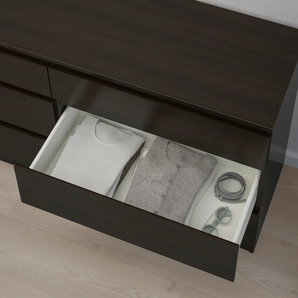 A dresser drawer opens, showing folded clothes and accessories.
