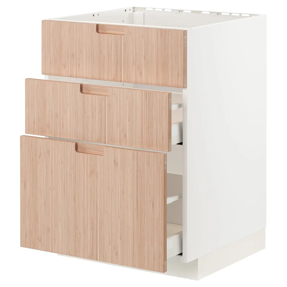 A white ikea METOD kitchen cabinet with three light bamboo drawers.
