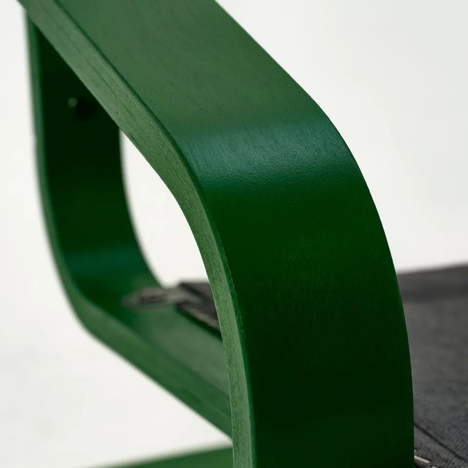 Bright green modern chair with smooth, curved edges and a glossy finish.