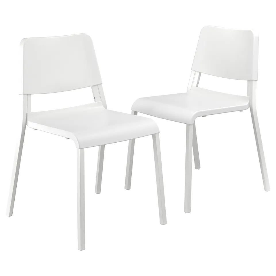 Two white plastic chairs with metal legs, simple design.
