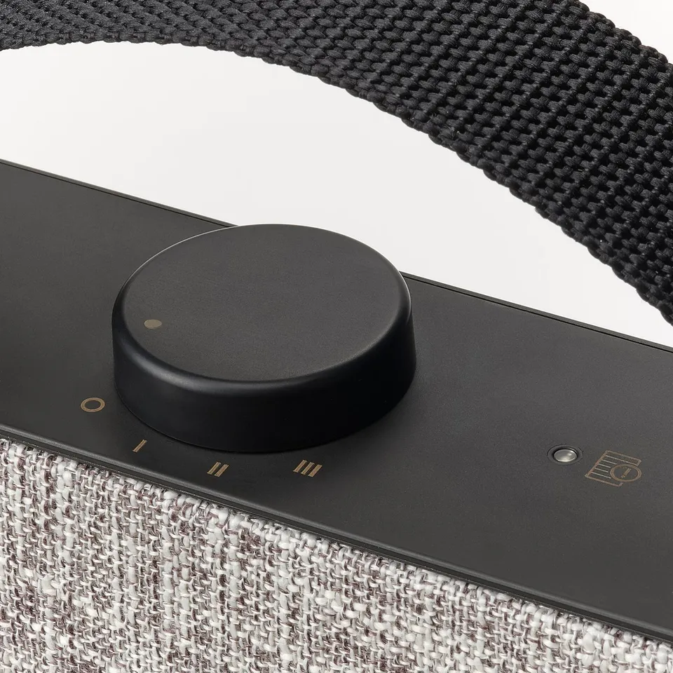 Black air purifier with circular dial.
