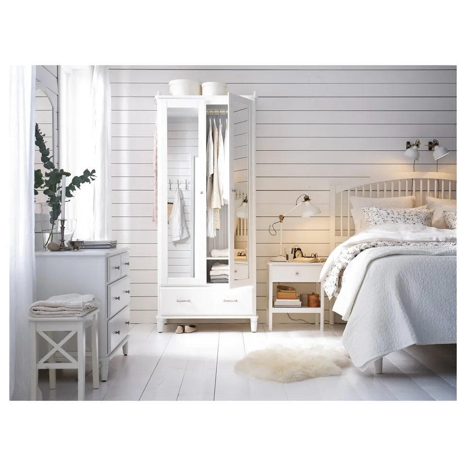 Bright white bedroom with TYSSEDAL wardrobe, dresser, and bed. Clean, minimalist design with wooden floors, shiplap walls, and cosy bedding.