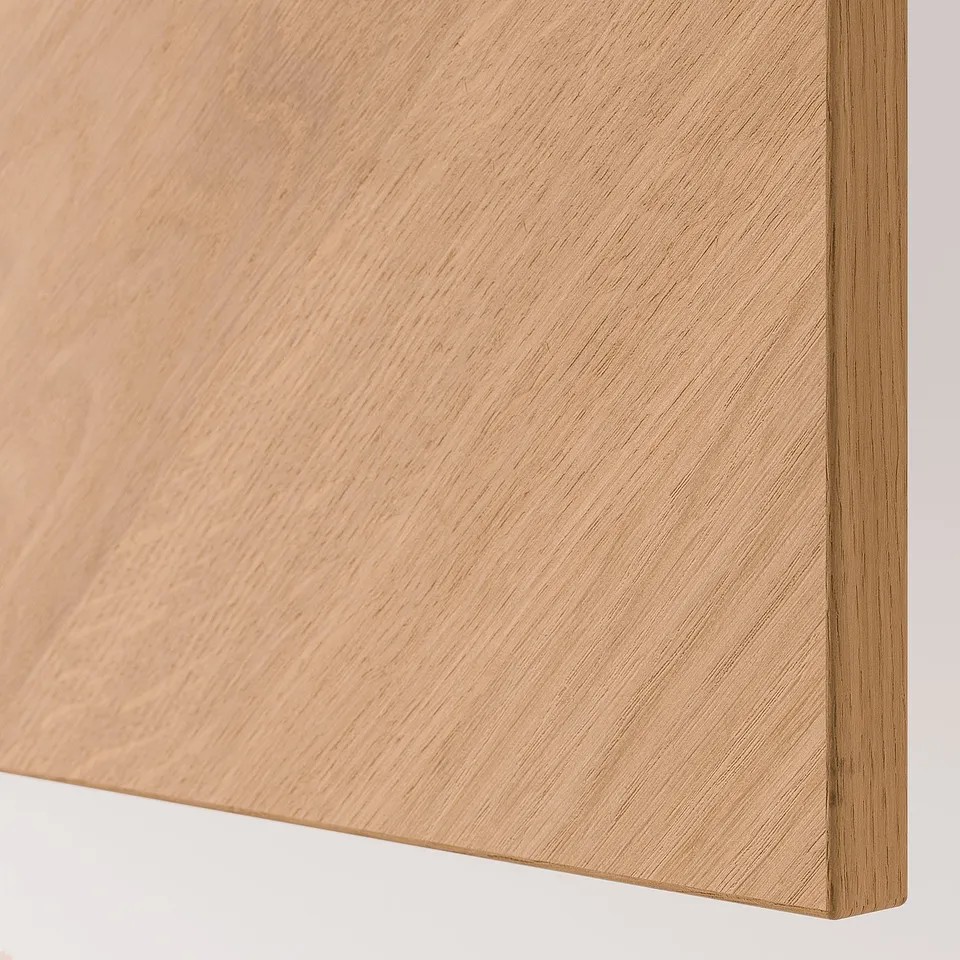 Close-up of smooth, light wood panel, showcasing quality grain and finish of BESTÅ furniture.