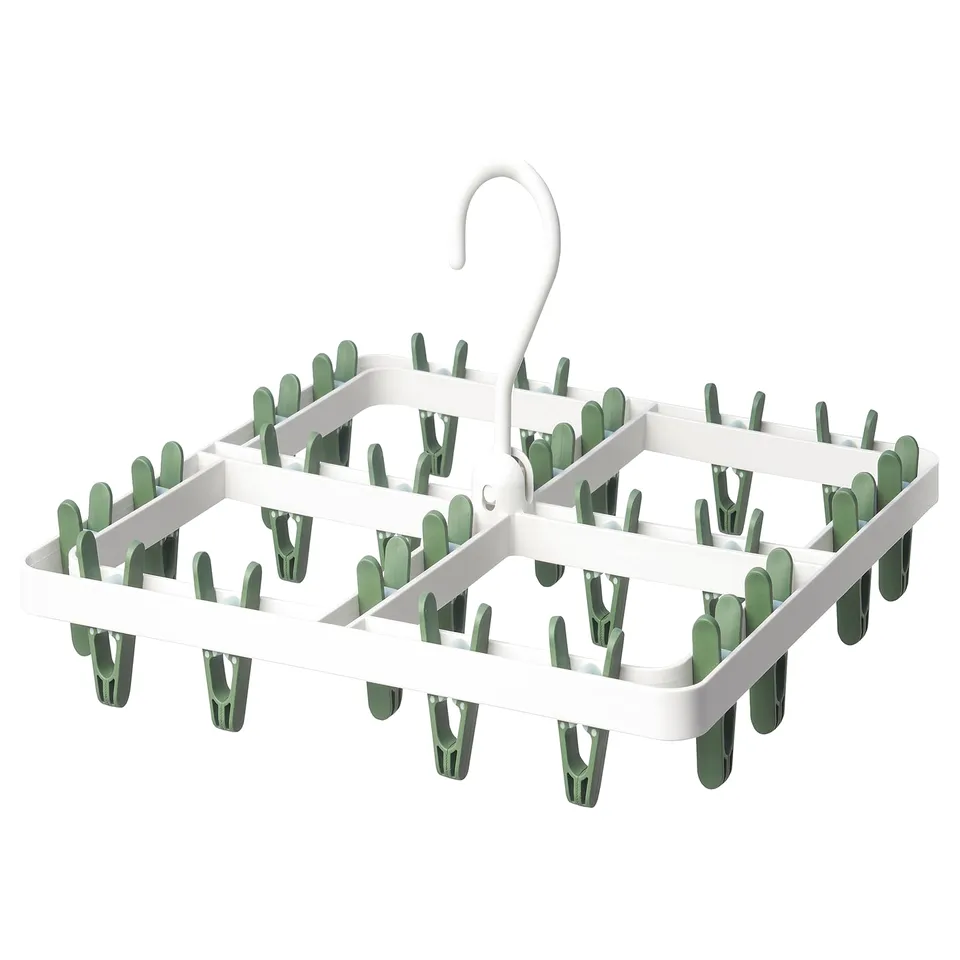 Green-pegged white dryer for socks & small items, folds for storage.
