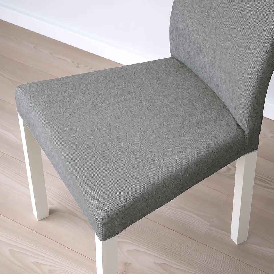 Modern chair with grey fabric seat and back, white legs.