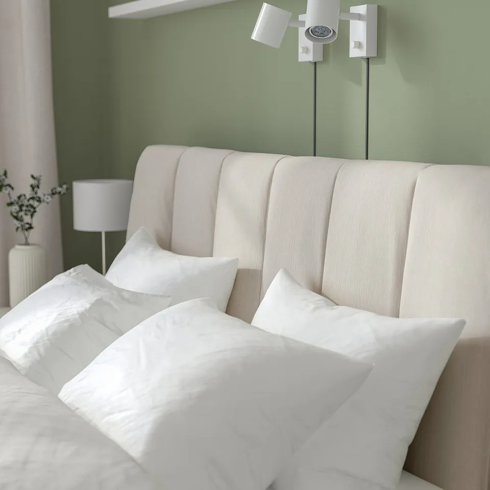 Cosy bed with adjustable sides, soft headboard, and under-bed storage. Modern design with pleasant lighting.