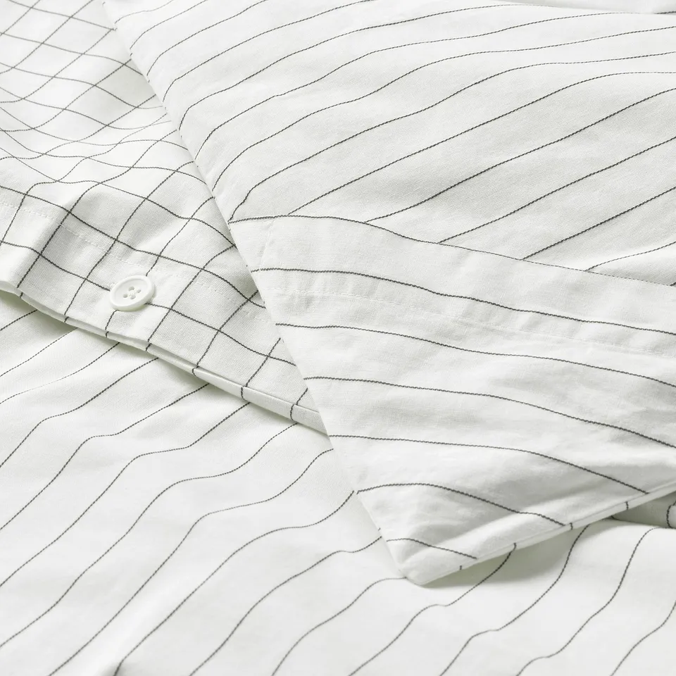 White duvet cover with stitched check pattern and stripes, easy corner pockets for duvet insertion.