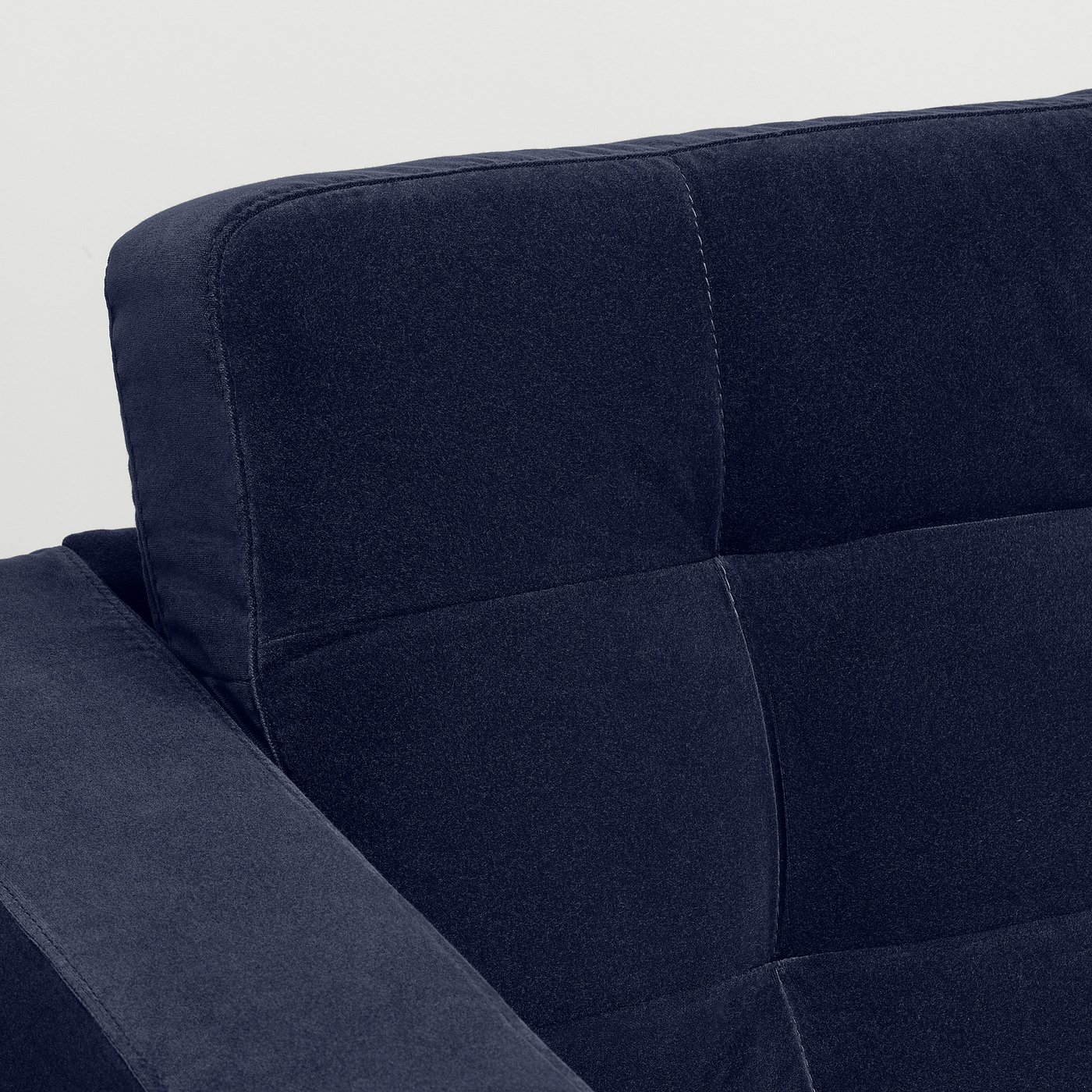 Close-up of a dark grey fabric armchair, showing its tailored design and high-quality upholstery.