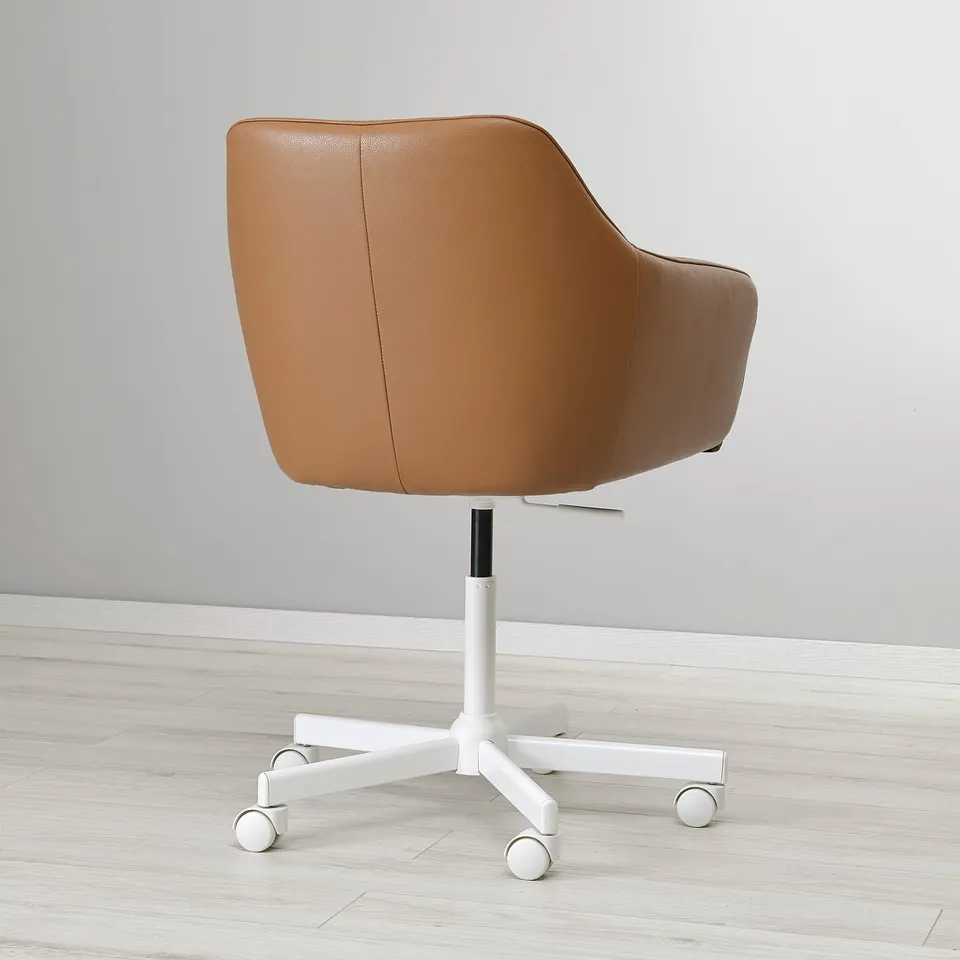Brown leather office chair with adjustable height, soft padding, and swivel wheels on a white base.
