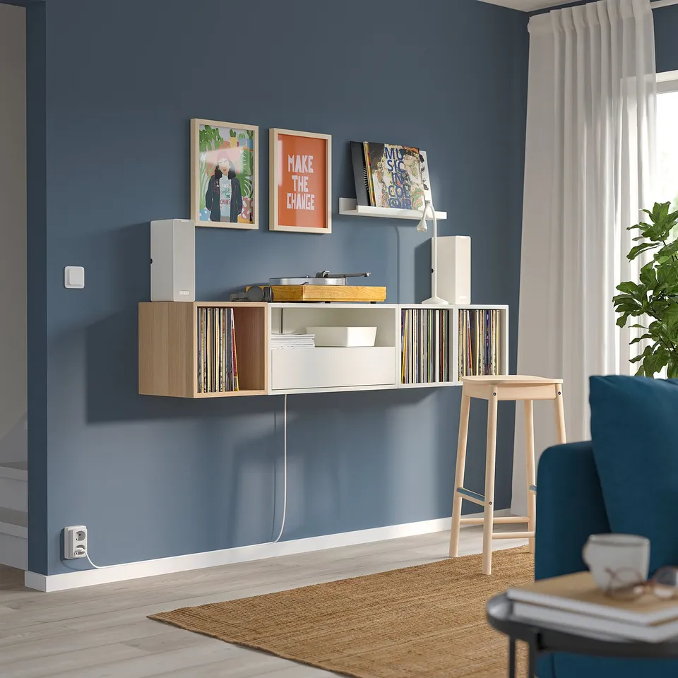 Blue living room with EKET storage, vinyls, art & cosy seating.