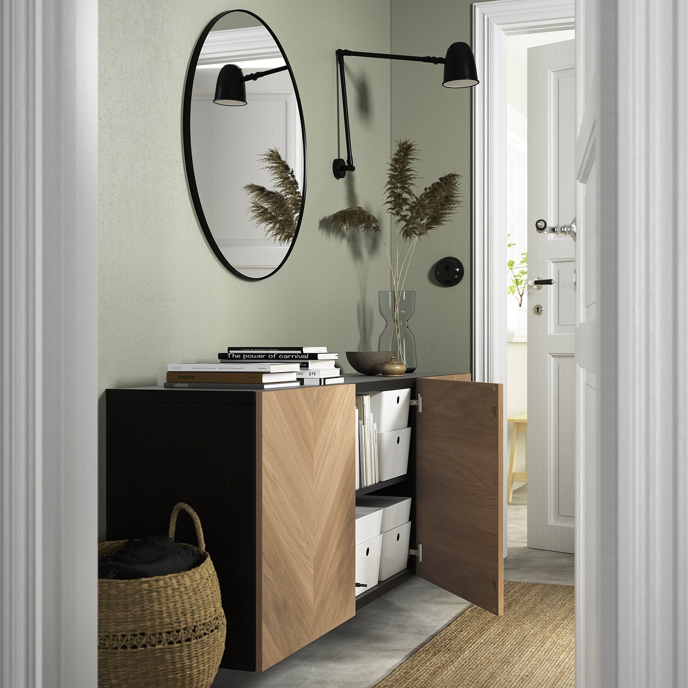 Wooden cabinet with open doors and shelves, displaying books and decor. Modern, clean design, oval wall mirror above.