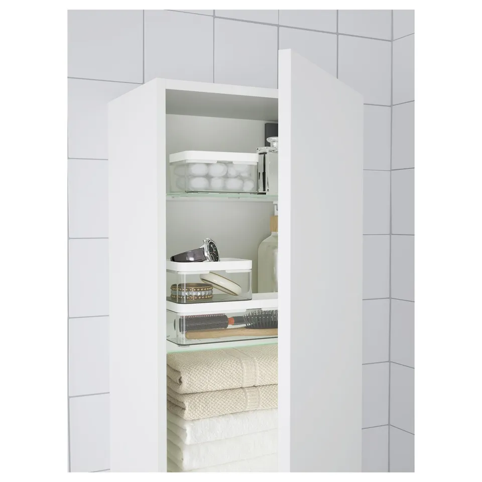 Small bathroom organiser shelves with transparent containers for jewellery, make-up, and folded towels. Keeps items visible and easily accessible.