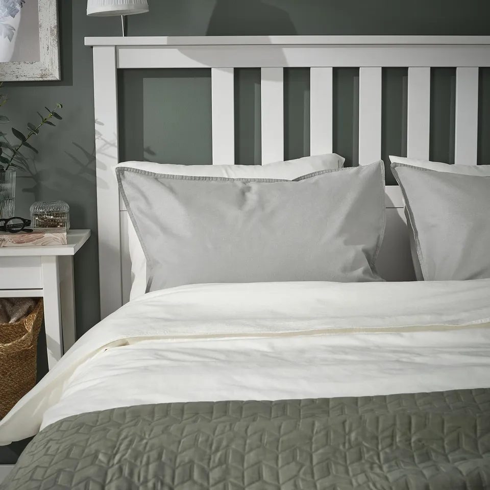 Courtesy: elegant bedding setup with white ÄNGSLILJA pillowcases on a large, textured green quilt. Simple yet cosy design.