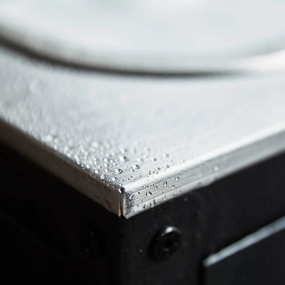Silver metal countertop with water droplets