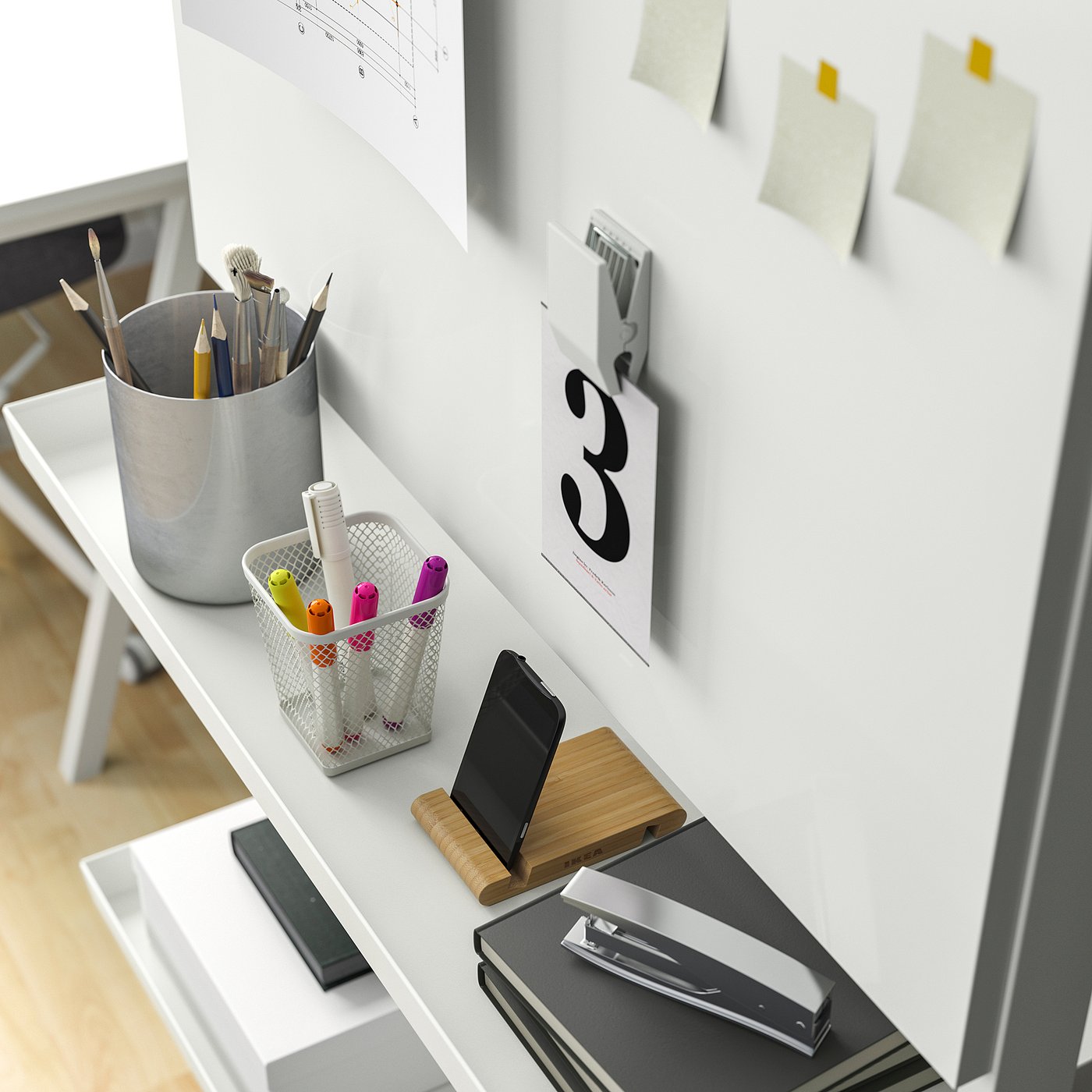 Organised workspace: shelf with supplies, notes, and phone stand.