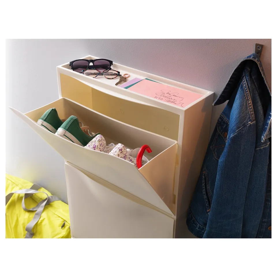 White TRONES shoe cabinet displays shoes and stores items.