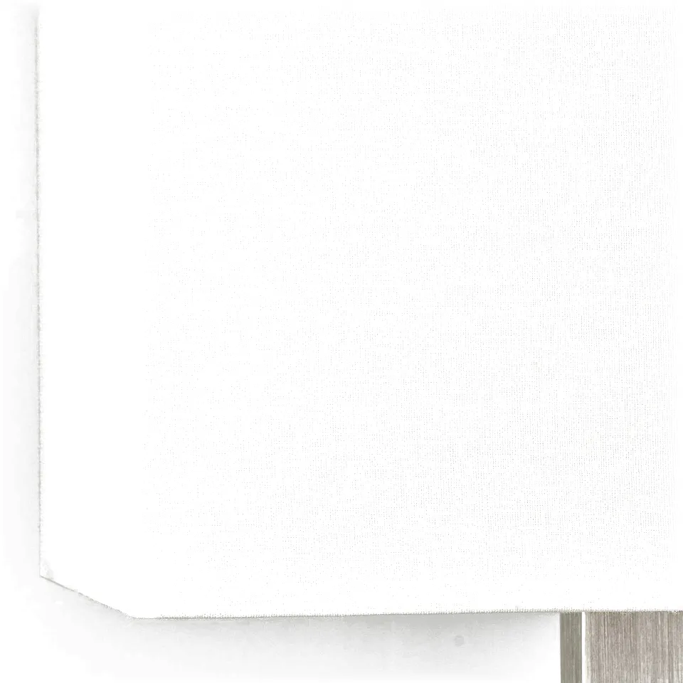 Modern lamp with rectangular white shade on metallic base; soft light.