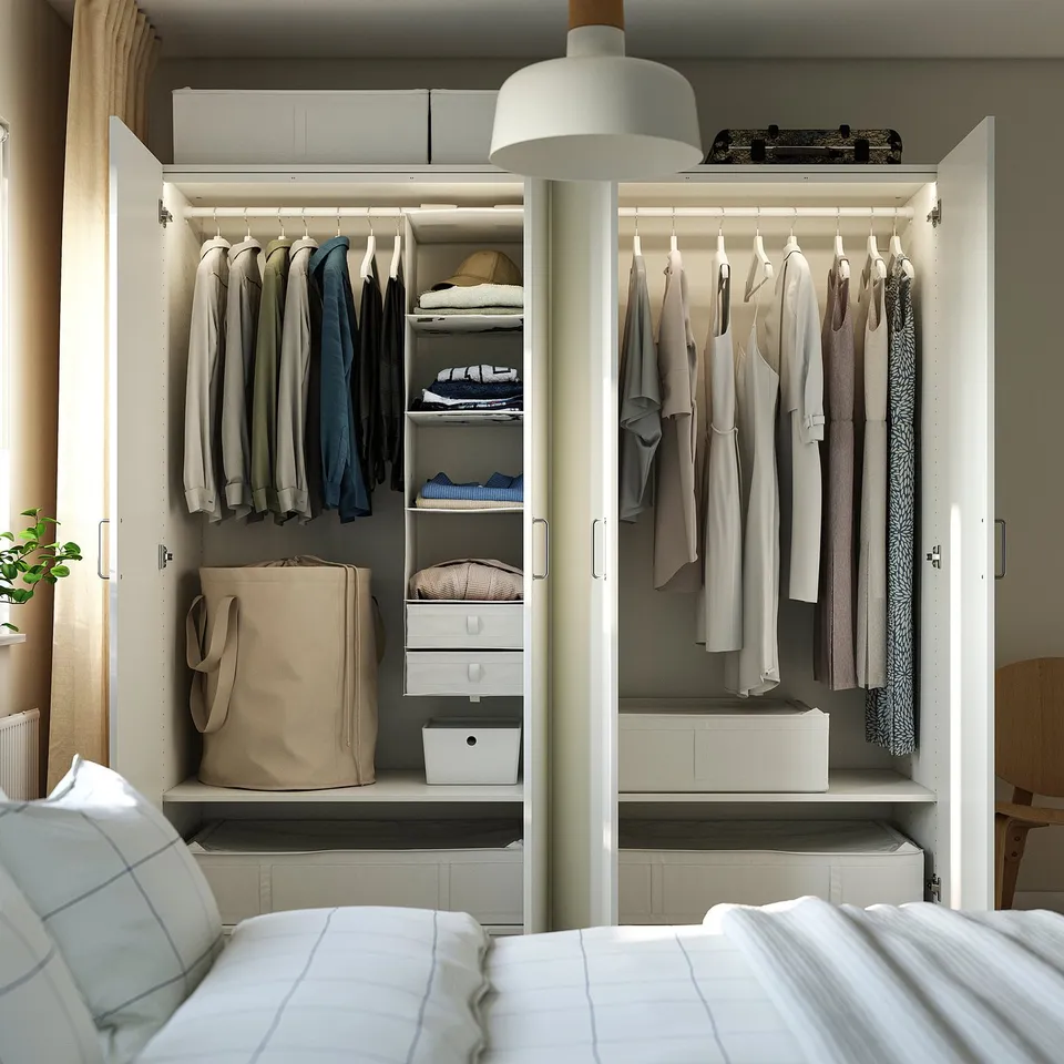 Closed wardrobe with clothes, drawers, and bags, neatly organised.